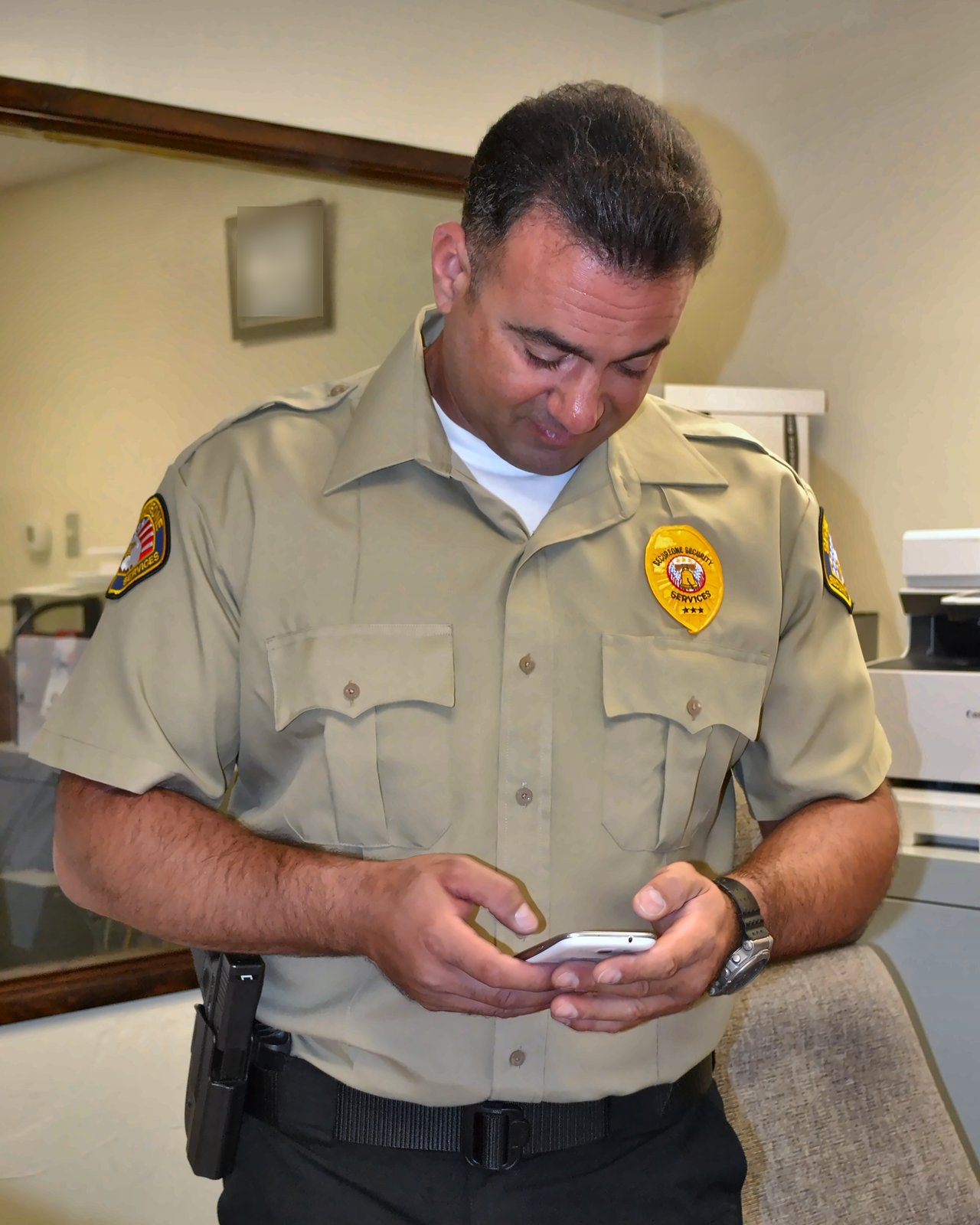 SecureOne security officer writing a report in an office
